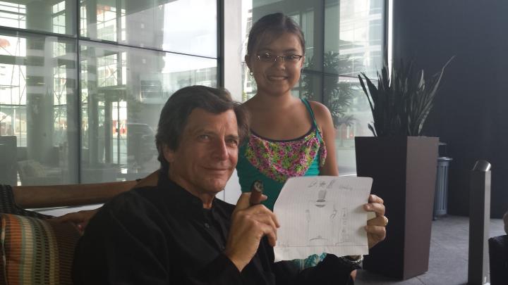 Dirk holding the picture Annabelle drew of him